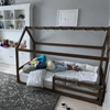 Cama montessori con casita de madera color moka en habitación
